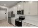 Modern kitchen with stainless steel appliances and white herringbone backsplash at 31472 Woodland Race Loop, Wesley Chapel, FL 33545