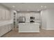 Modern kitchen with island, stainless steel appliances, and light gray cabinets at 31472 Woodland Race Loop, Wesley Chapel, FL 33545