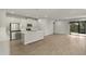 Open floor plan with modern kitchen and spacious living area leading to a patio at 31472 Woodland Race Loop, Wesley Chapel, FL 33545