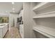 White built-in shelving in a spacious kitchen pantry at 31496 Woodland Race Loop, Wesley Chapel, FL 33545