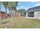 Spacious backyard with grassy area and tropical plants at 31935 Brookstone Dr, Wesley Chapel, FL 33545