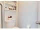 Clean bathroom with toilet, shelving, and wall-mounted storage at 31935 Brookstone Dr, Wesley Chapel, FL 33545