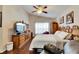 Primary bedroom with a large bed, dresser, and window with curtains at 31935 Brookstone Dr, Wesley Chapel, FL 33545