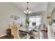 Elegant dining room with a wood table, six chairs, hardwood floors and a chandelier at 31935 Brookstone Dr, Wesley Chapel, FL 33545