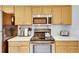 Stainless steel appliances and light wood cabinets in this kitchen at 31935 Brookstone Dr, Wesley Chapel, FL 33545