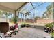 Spacious screened porch overlooking a backyard with palm trees at 31935 Brookstone Dr, Wesley Chapel, FL 33545