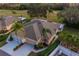 Aerial view of a house with a golf course in the background at 2003 Acadia Greens Dr, Sun City Center, FL 33573
