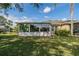 Home exterior with sunroom and yard view at 2003 Acadia Greens Dr, Sun City Center, FL 33573