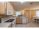 Spacious kitchen with light wood cabinets, appliances, and breakfast bar at 2003 Acadia Greens Dr, Sun City Center, FL 33573