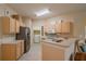Kitchen with stainless steel appliances and light wood cabinets at 2003 Acadia Greens Dr, Sun City Center, FL 33573