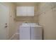 Laundry room with washer, dryer, and shelving at 2003 Acadia Greens Dr, Sun City Center, FL 33573