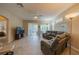 Living room with a sectional sofa and sliding glass doors to patio at 2003 Acadia Greens Dr, Sun City Center, FL 33573