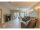 Living room with a sectional sofa and sliding glass doors to patio at 2003 Acadia Greens Dr, Sun City Center, FL 33573