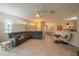 Spacious living room featuring a large sectional sofa and tile flooring at 2003 Acadia Greens Dr, Sun City Center, FL 33573
