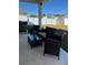 Relaxing covered patio with seating area overlooks grassy backyard at 6625 Pebblebrooke Way, Zephyrhills, FL 33541