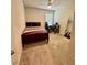 Bedroom with a full-size bed, gaming setup, and a mirror at 6625 Pebblebrooke Way, Zephyrhills, FL 33541