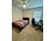Bedroom with a full-size bed, gaming setup, and a mirror at 6625 Pebblebrooke Way, Zephyrhills, FL 33541