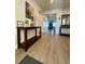 Bright and spacious entryway with wood-look flooring and a console table at 6625 Pebblebrooke Way, Zephyrhills, FL 33541