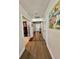 Long hallway with light walls, wood-look floors, and french doors to other rooms at 6625 Pebblebrooke Way, Zephyrhills, FL 33541