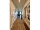 Bright hallway with hardwood floors, leading to the living areas and bedrooms at 6625 Pebblebrooke Way, Zephyrhills, FL 33541