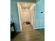 Bright hallway with wood-look floors and linen closet at 6625 Pebblebrooke Way, Zephyrhills, FL 33541