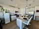 Modern kitchen featuring white shaker cabinets, stainless steel appliances, and an island at 6625 Pebblebrooke Way, Zephyrhills, FL 33541