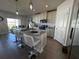 Modern kitchen with granite countertops and white cabinets at 6625 Pebblebrooke Way, Zephyrhills, FL 33541