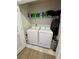 Laundry closet with washer, dryer, and shelving at 6625 Pebblebrooke Way, Zephyrhills, FL 33541