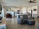 Spacious living area with hardwood floors and grey sofas at 6625 Pebblebrooke Way, Zephyrhills, FL 33541
