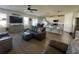 Open concept living room with hardwood floors and grey sofas at 6625 Pebblebrooke Way, Zephyrhills, FL 33541