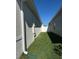 Landscaped side yard with grassy area and exterior utilities at 6625 Pebblebrooke Way, Zephyrhills, FL 33541