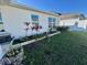 Landscaped side yard with flower bed and grassy area at 6625 Pebblebrooke Way, Zephyrhills, FL 33541