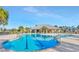 Community lap pool with spacious deck and lounge chairs at 11728 Cambium Crown Dr, Riverview, FL 33569