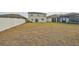 Large backyard with a view of the pond and community at 14319 Italia Dr, Wimauma, FL 33598