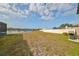 Spacious backyard with pond views, privacy fence, and grilling area at 14319 Italia Dr, Wimauma, FL 33598