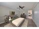 Primary bedroom with large bed and view into another room at 14319 Italia Dr, Wimauma, FL 33598