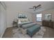 Comfortable bedroom with large bed and bench at the foot at 14319 Italia Dr, Wimauma, FL 33598