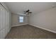Simple bedroom with ceiling fan and double-door closet at 14319 Italia Dr, Wimauma, FL 33598