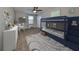 Bedroom with bunk beds, desk, and ceiling fan at 14319 Italia Dr, Wimauma, FL 33598