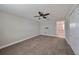 Large bedroom with ceiling fan and access to another room at 14319 Italia Dr, Wimauma, FL 33598
