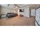 Spacious Primary bedroom with large bed and TV at 14319 Italia Dr, Wimauma, FL 33598