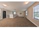 Spacious bonus room with neutral carpeting and large windows at 14319 Italia Dr, Wimauma, FL 33598