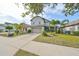Two-story house with gray siding, light blue shutters, and a stone facade at 14319 Italia Dr, Wimauma, FL 33598