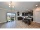 Modern kitchen with dark cabinetry, granite countertops, and stainless steel appliances at 14319 Italia Dr, Wimauma, FL 33598