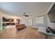 Open concept living room and kitchen with a couch and wood-look floors at 14319 Italia Dr, Wimauma, FL 33598