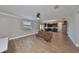 Open living room with wood-look floors and a view of the kitchen at 14319 Italia Dr, Wimauma, FL 33598