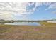 Peaceful pond view with surrounding homes and lush landscape at 14319 Italia Dr, Wimauma, FL 33598