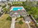 Community pool with lounge chairs and surrounding landscaping at 14319 Italia Dr, Wimauma, FL 33598