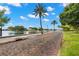 Brick paved waterfront pathway lined with palm trees at 2311 Brevard Ne Rd, St Petersburg, FL 33704