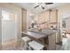 Galley kitchen with light cabinets, granite counters, and island at 2311 Brevard Ne Rd, St Petersburg, FL 33704